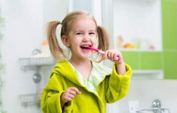 happy girl brushes teeth